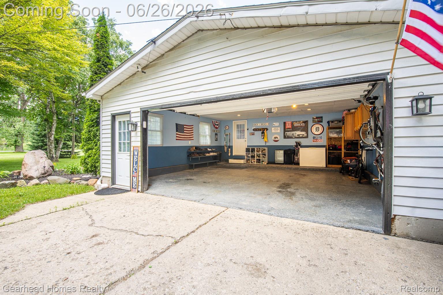 12364 Morrish Road Clio, MI 48420 - Photo 48 of 81 Two-car garage with overhead door, concrete driveway, and side entry door