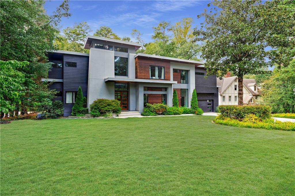 a front view of house with yard and green space