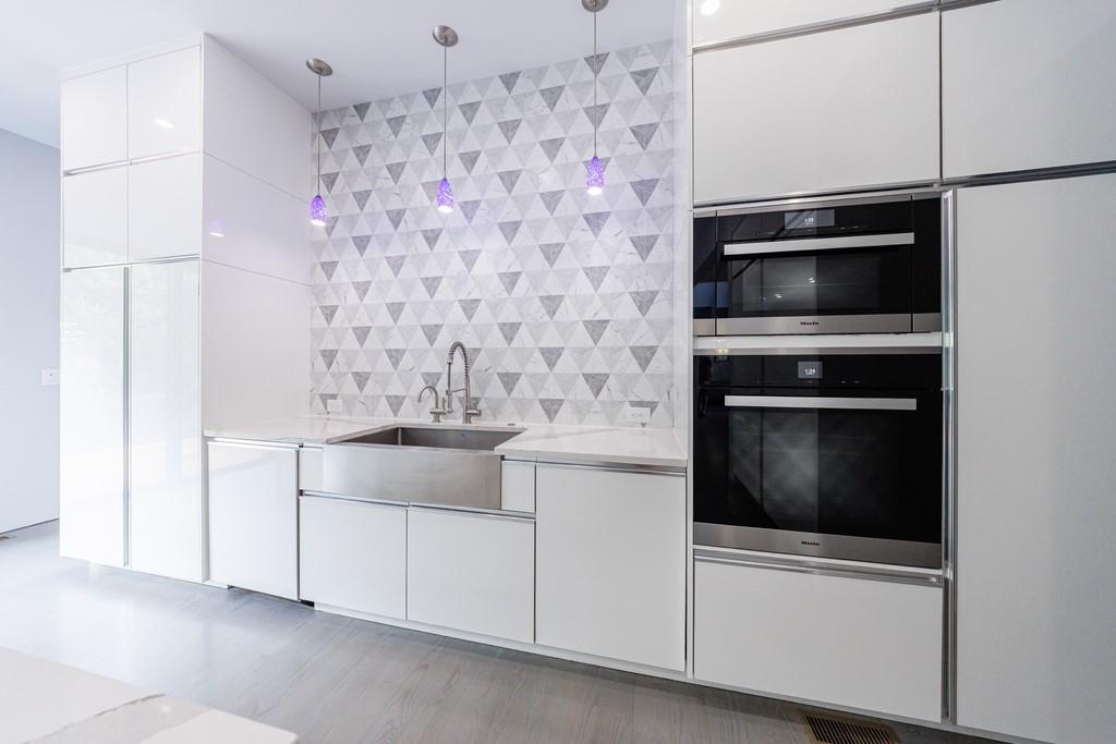 4036 Statewood Road Northeast Atlanta, GA 30342 - Photo 12 of 84 a kitchen with granite countertop white cabinets and stainless steel appliances