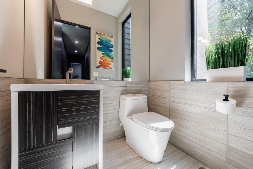 4036 Statewood Road Northeast Atlanta, GA 30342 - Photo 19 of 84 a bathroom with a toilet a sink and mirror