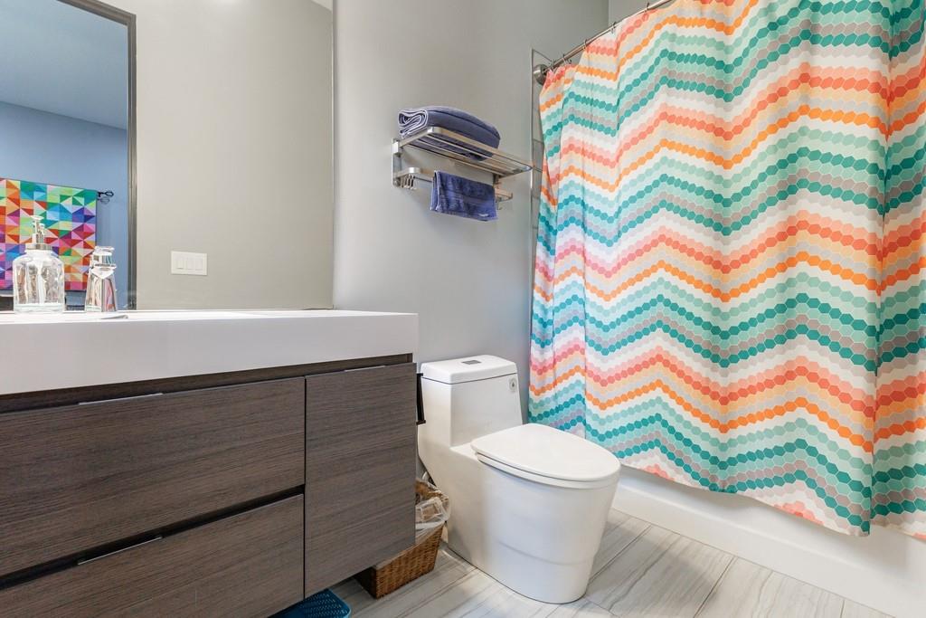 4036 Statewood Road Northeast Atlanta, GA 30342 - Photo 36 of 84 a bathroom with a sink toilet and a shower curtain