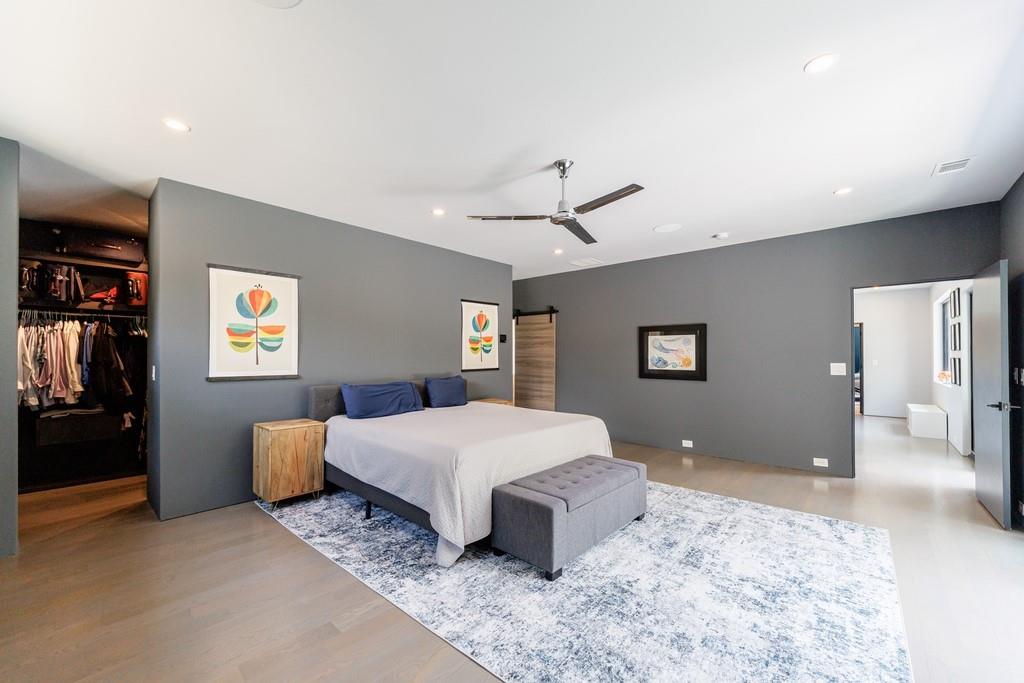 4036 Statewood Road Northeast Atlanta, GA 30342 - Photo 38 of 84 a spacious bedroom with a large bed and a chandelier