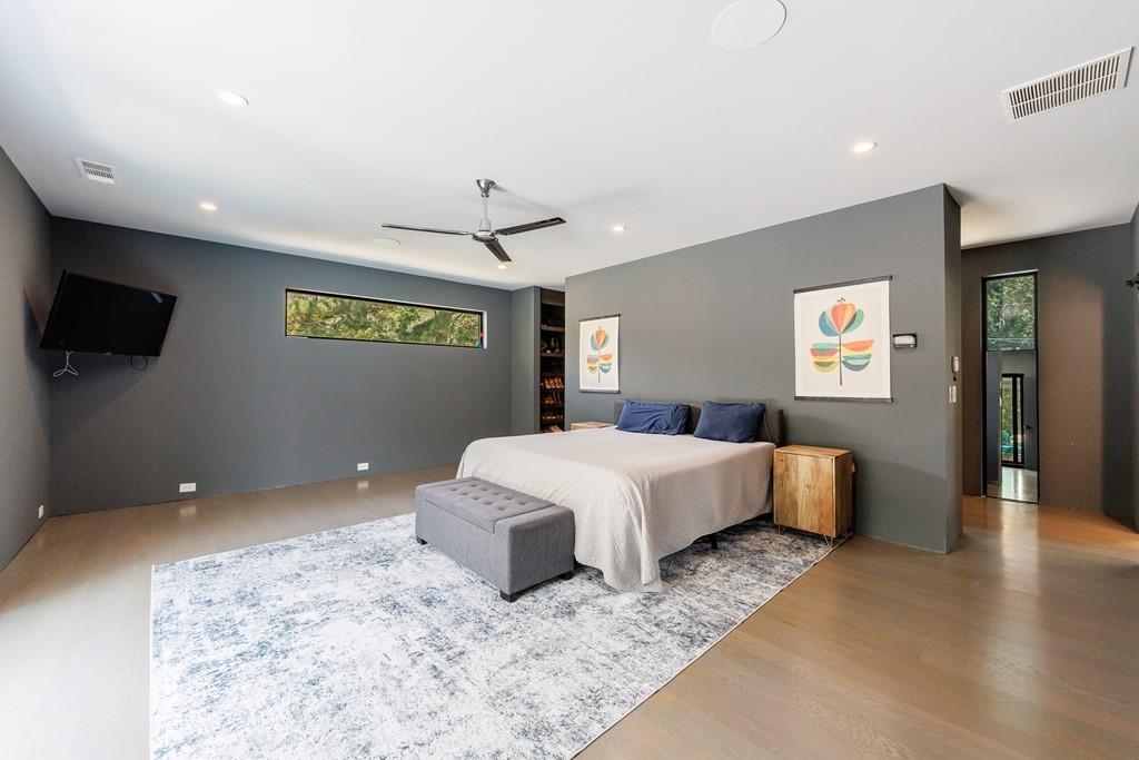 4036 Statewood Road Northeast Atlanta, GA 30342 - Photo 39 of 84 a spacious bedroom with a bed and a flat screen tv