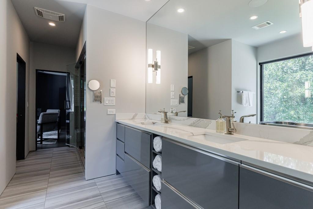 4036 Statewood Road Northeast Atlanta, GA 30342 - Photo 41 of 84 a en suite bathroom with a double vanity sink a mirror and a shower