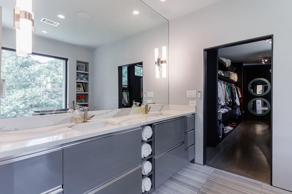 4036 Statewood Road Northeast Atlanta, GA 30342 - Photo 42 of 84 a bathroom with a double vanity sink and a large mirror