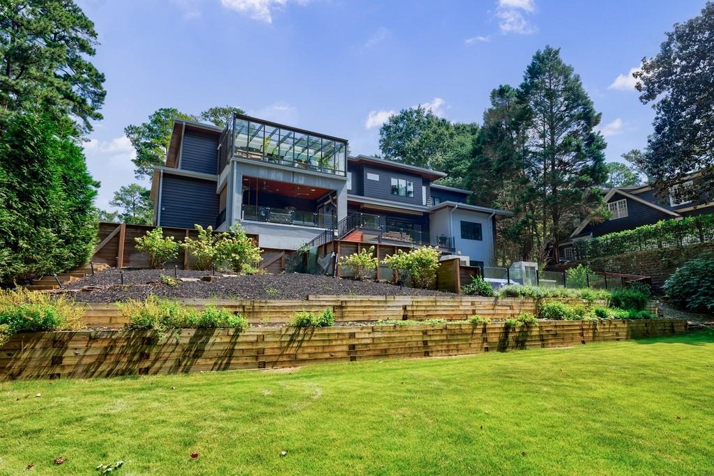 4036 Statewood Road Northeast Atlanta, GA 30342 - Photo 78 of 84 a view of a house with a big yard potted plants and large tree