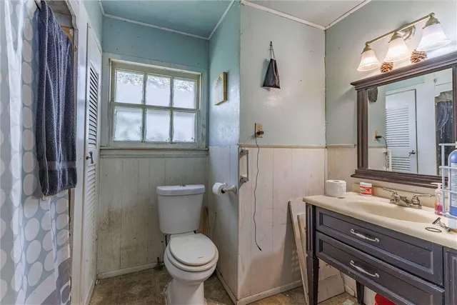 a bathroom with a sink toilet and window
