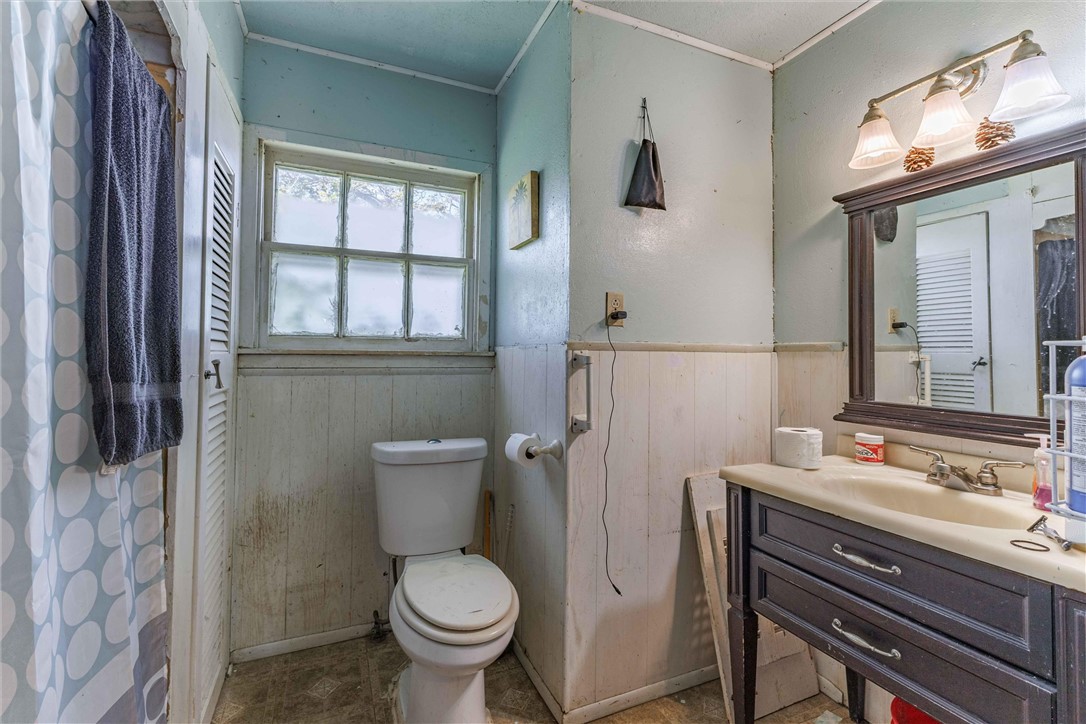 3840 Parrish Street Waco, TX 76705 - Photo 11 of 17 a bathroom with a sink toilet and window