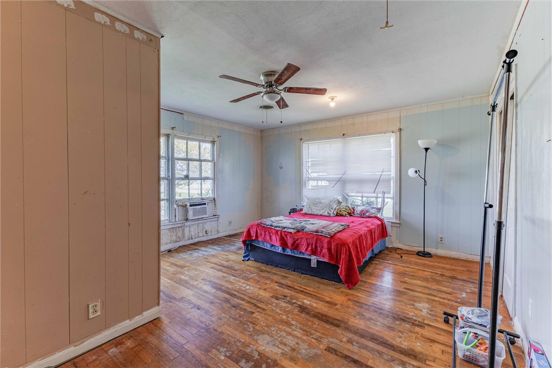 3840 Parrish Street Waco, TX 76705 - Photo 12 of 17 a spacious bedroom with a bed and wooden floor