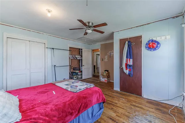 a bedroom with a large bed and a chandelier