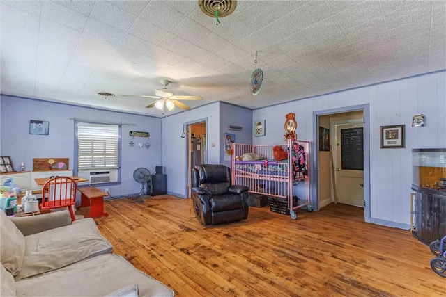 a bedroom with furniture and a wooden floor