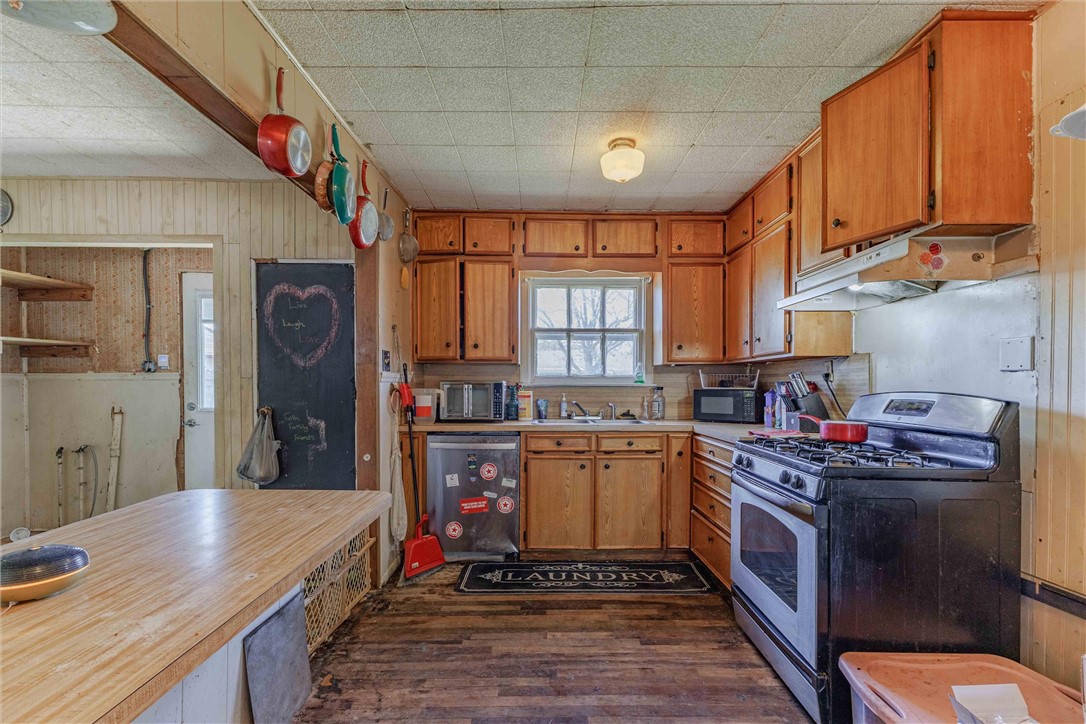 3840 Parrish Street Waco, TX 76705 - Photo 5 of 17 a kitchen with stainless steel appliances granite countertop a stove a sink dishwasher and cabinets with wooden floor