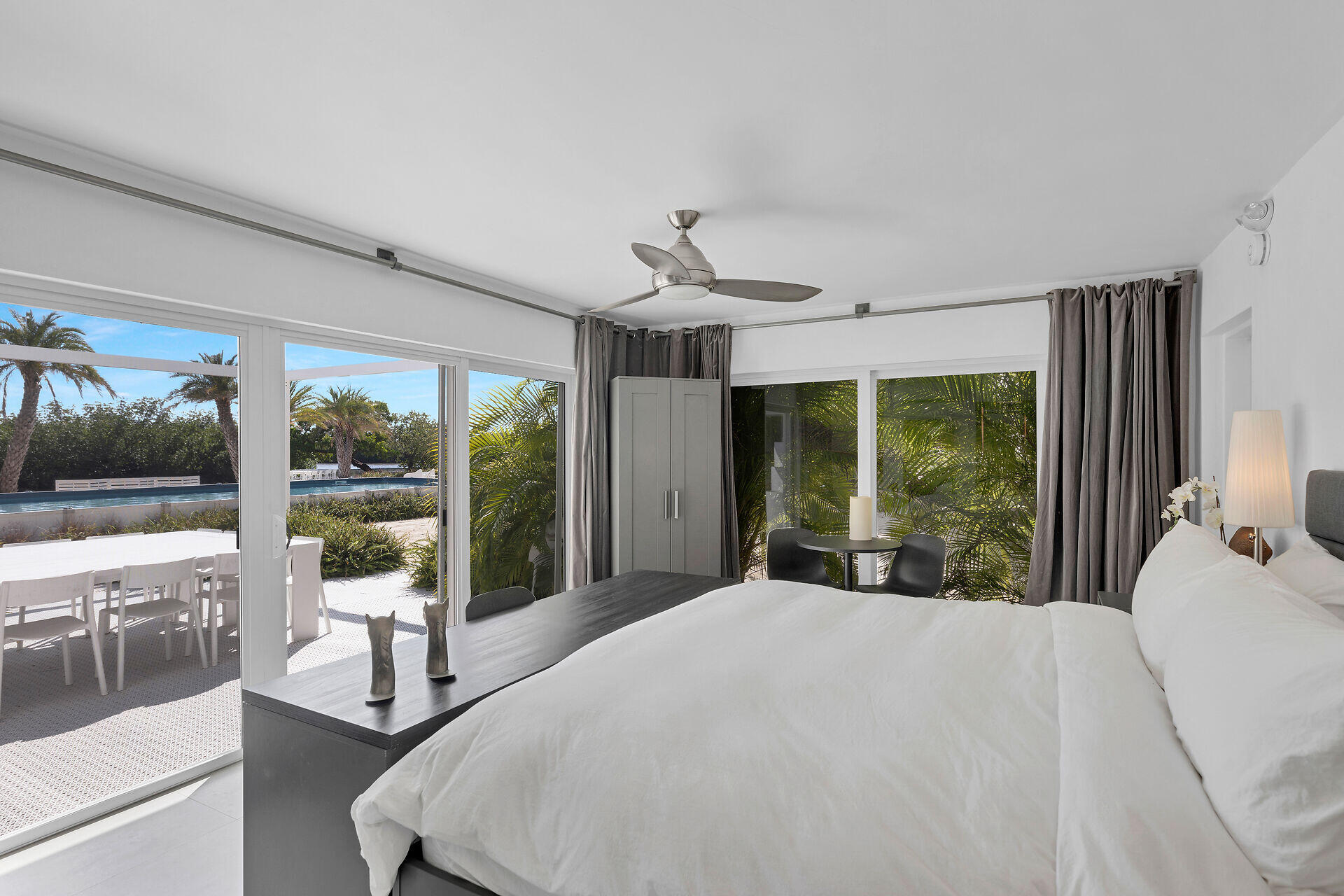 98701 Overseas Highway Key Largo, FL 33037 - Photo 19 of 47 a bed sitting in a bedroom next to a large window with balcony view