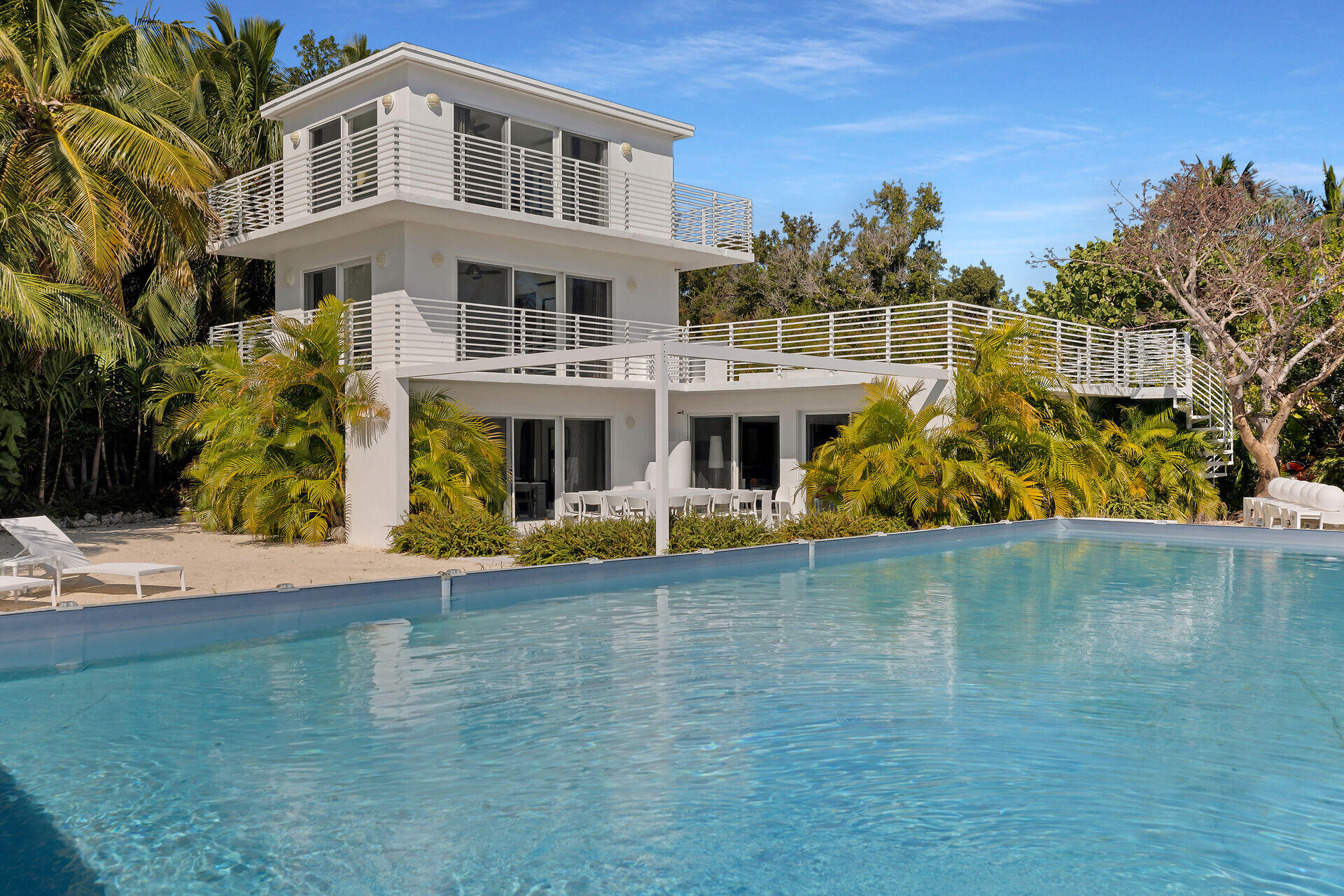 98701 Overseas Highway Key Largo, FL 33037 - Photo 2 of 47 a front view of a house with swimming pool