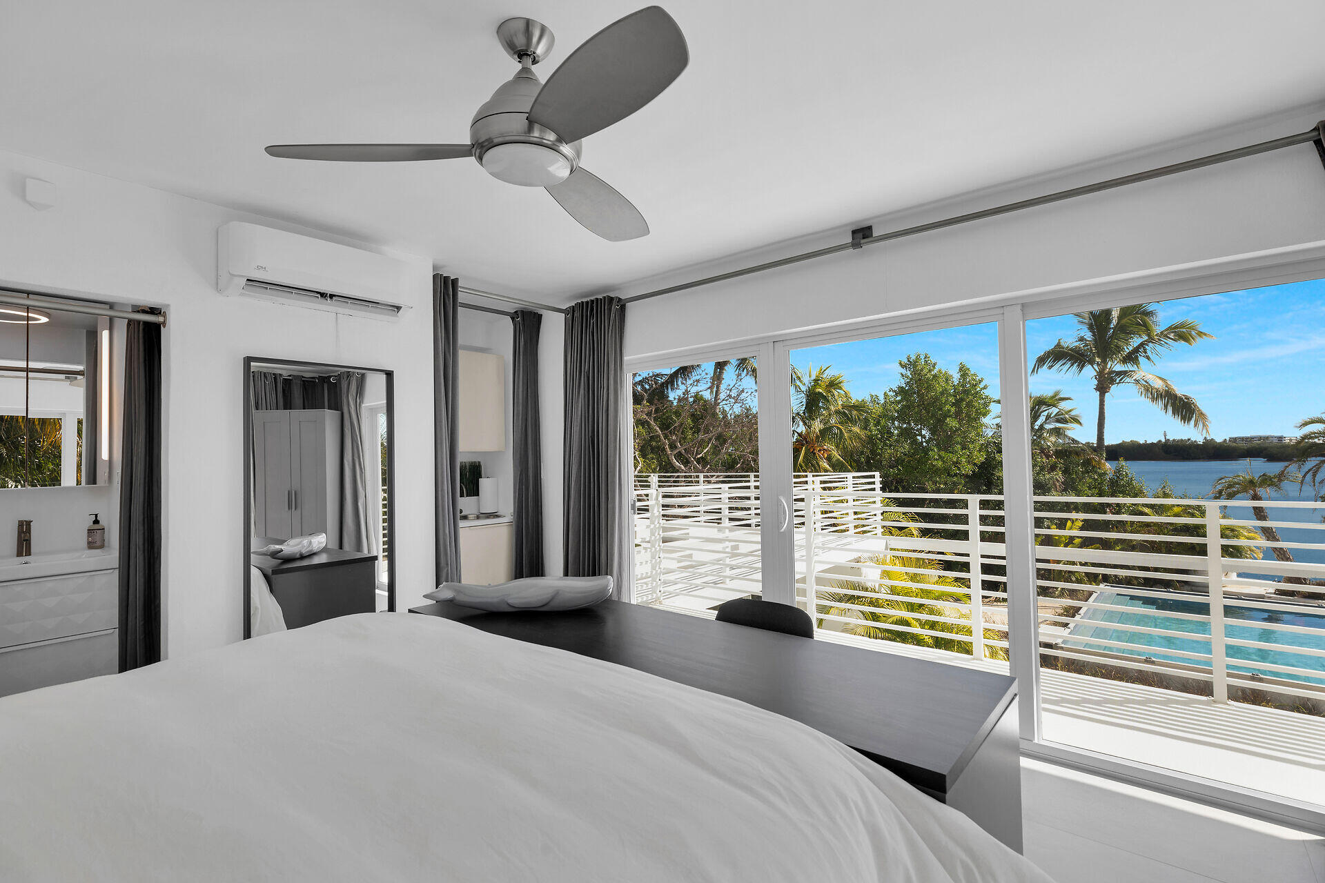 98701 Overseas Highway Key Largo, FL 33037 - Photo 24 of 47 a bedroom with a bed and glass windows