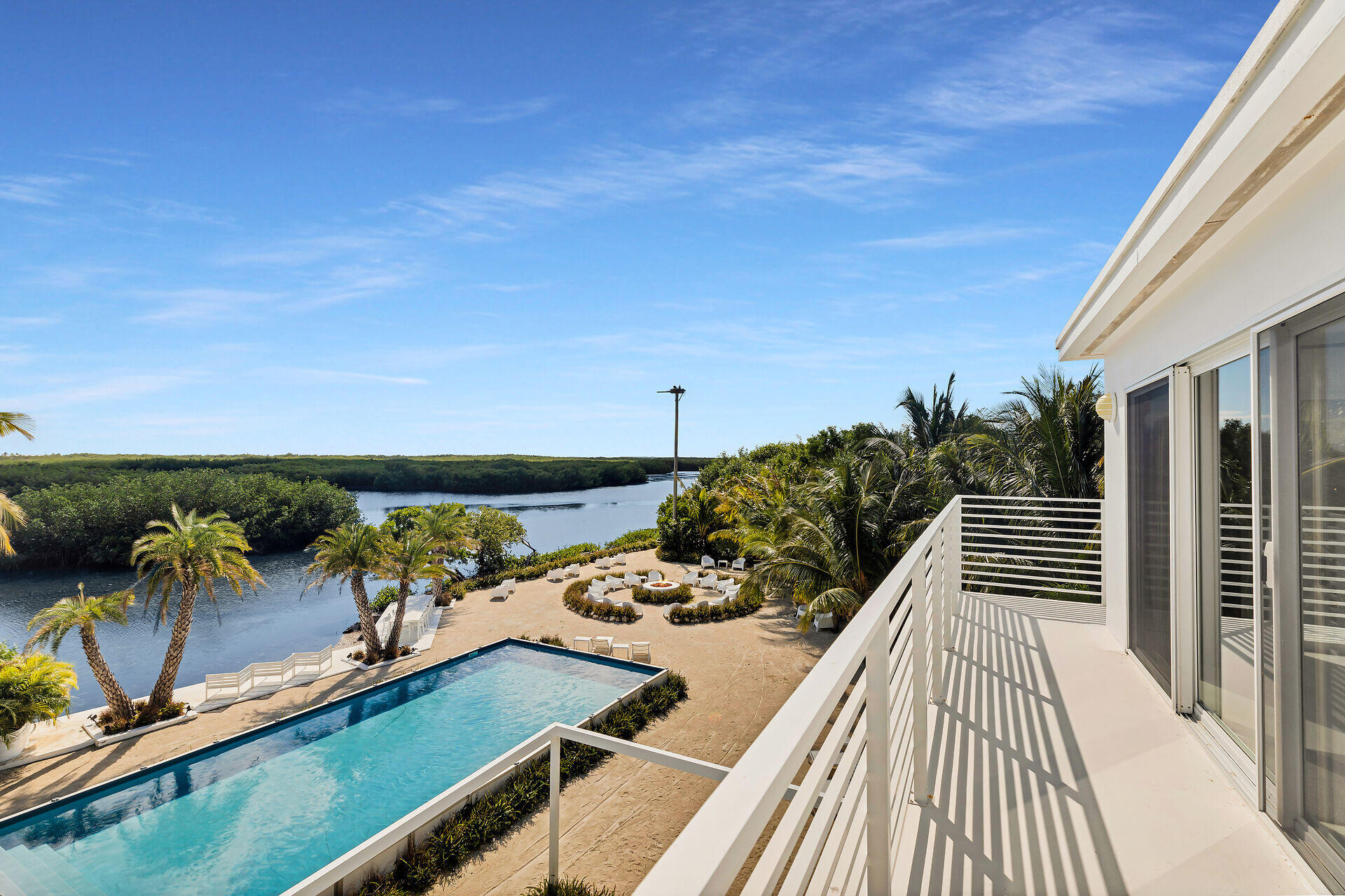 98701 Overseas Highway Key Largo, FL 33037 - Photo 27 of 47 a view of a balcony with chairs and wooden floor
