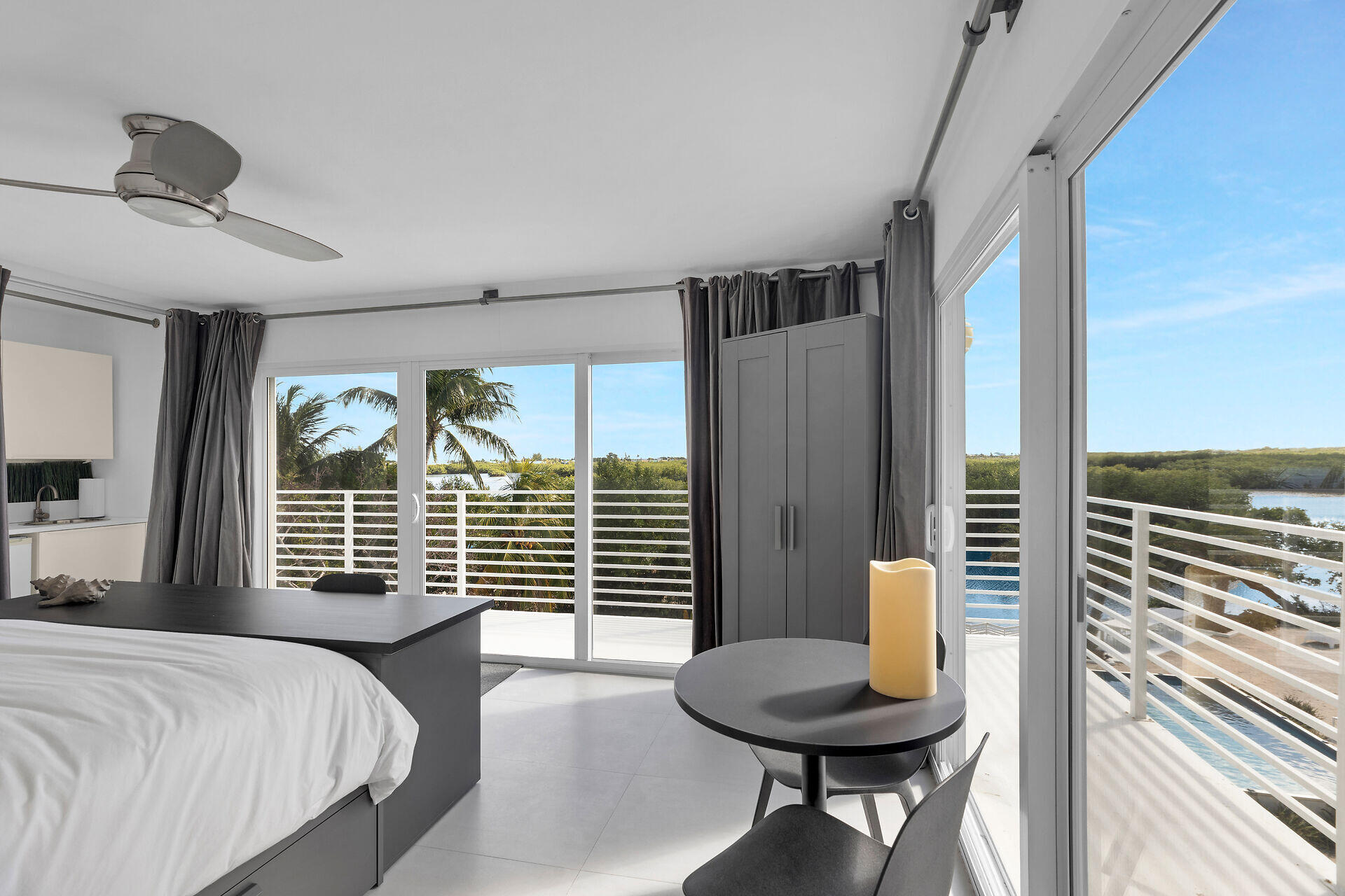 98701 Overseas Highway Key Largo, FL 33037 - Photo 28 of 47 a bedroom with a bed and a chandelier