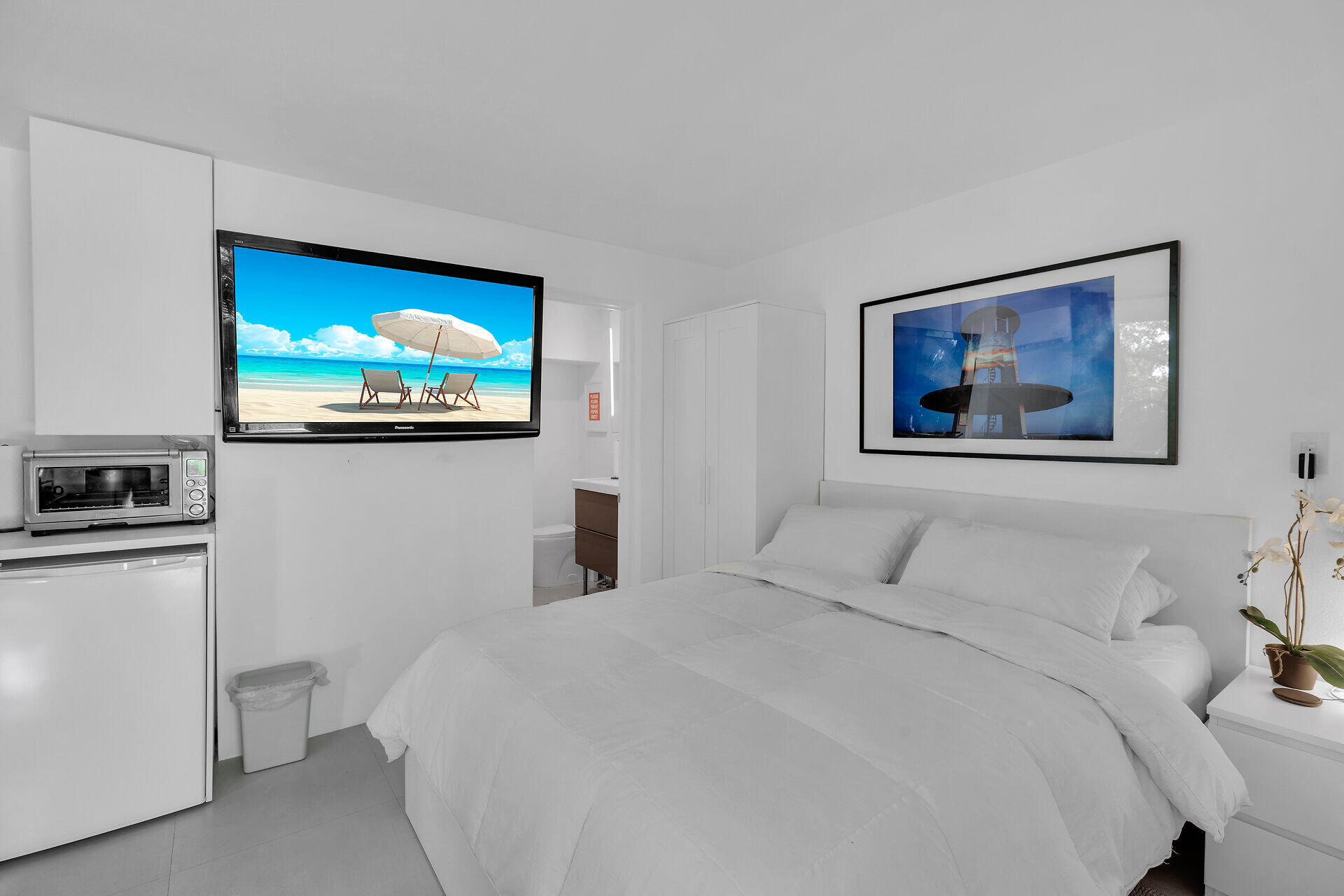 98701 Overseas Highway Key Largo, FL 33037 - Photo 31 of 47 a bedroom with a bed and a flat screen tv