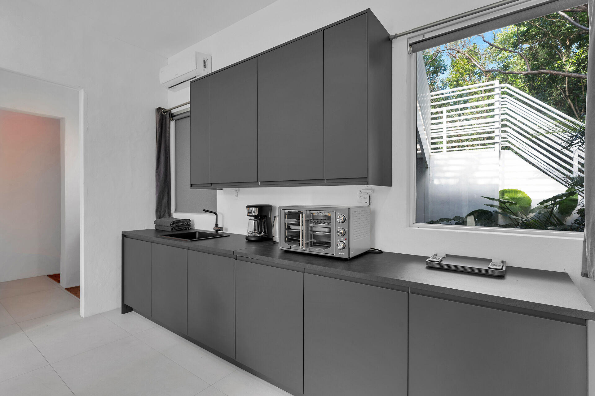 98701 Overseas Highway Key Largo, FL 33037 - Photo 37 of 47 a kitchen with stainless steel appliances a sink a stove and a window