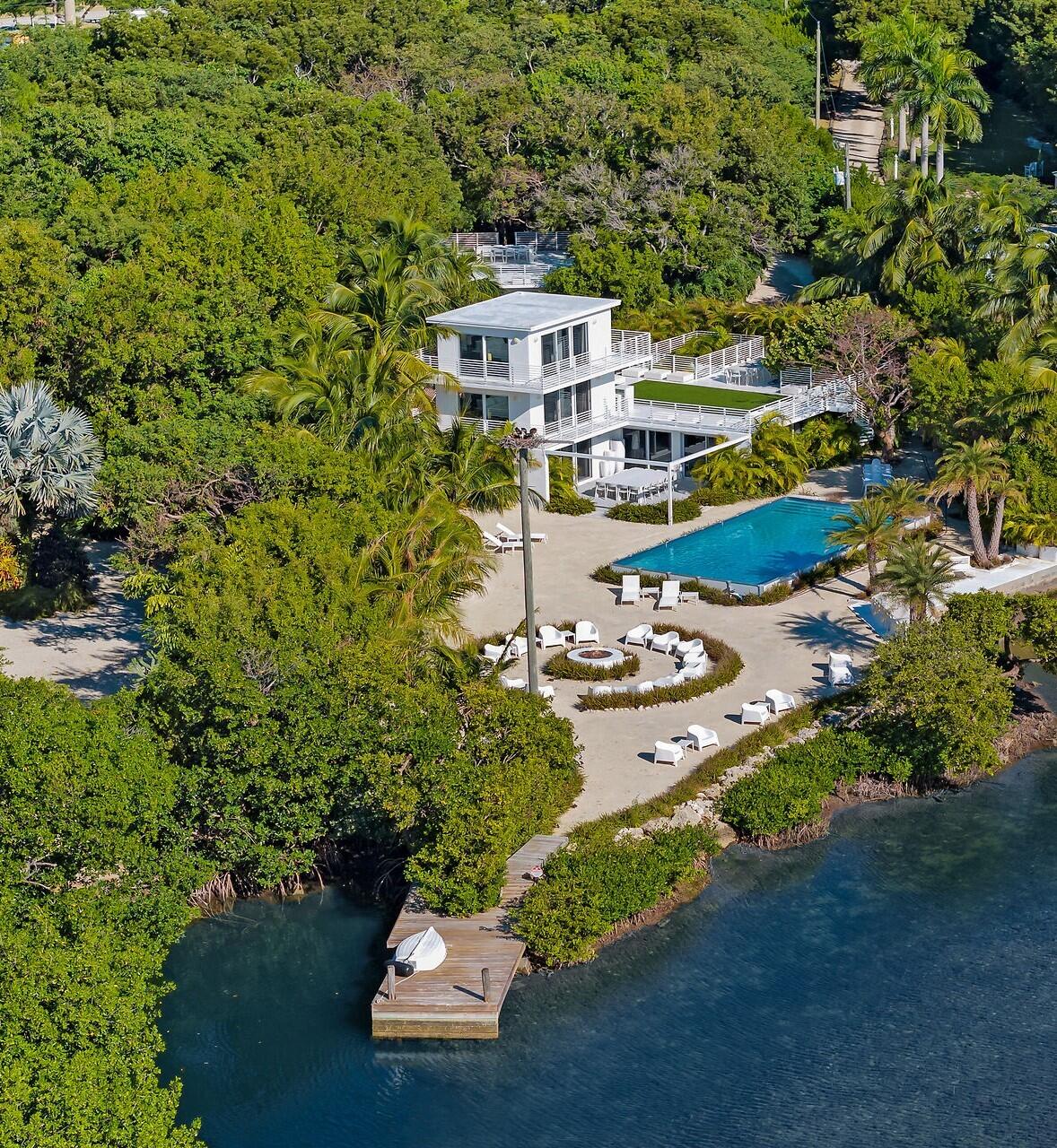 98701 Overseas Highway Key Largo, FL 33037 - Photo 4 of 47 a view of a house with a yard and balcony