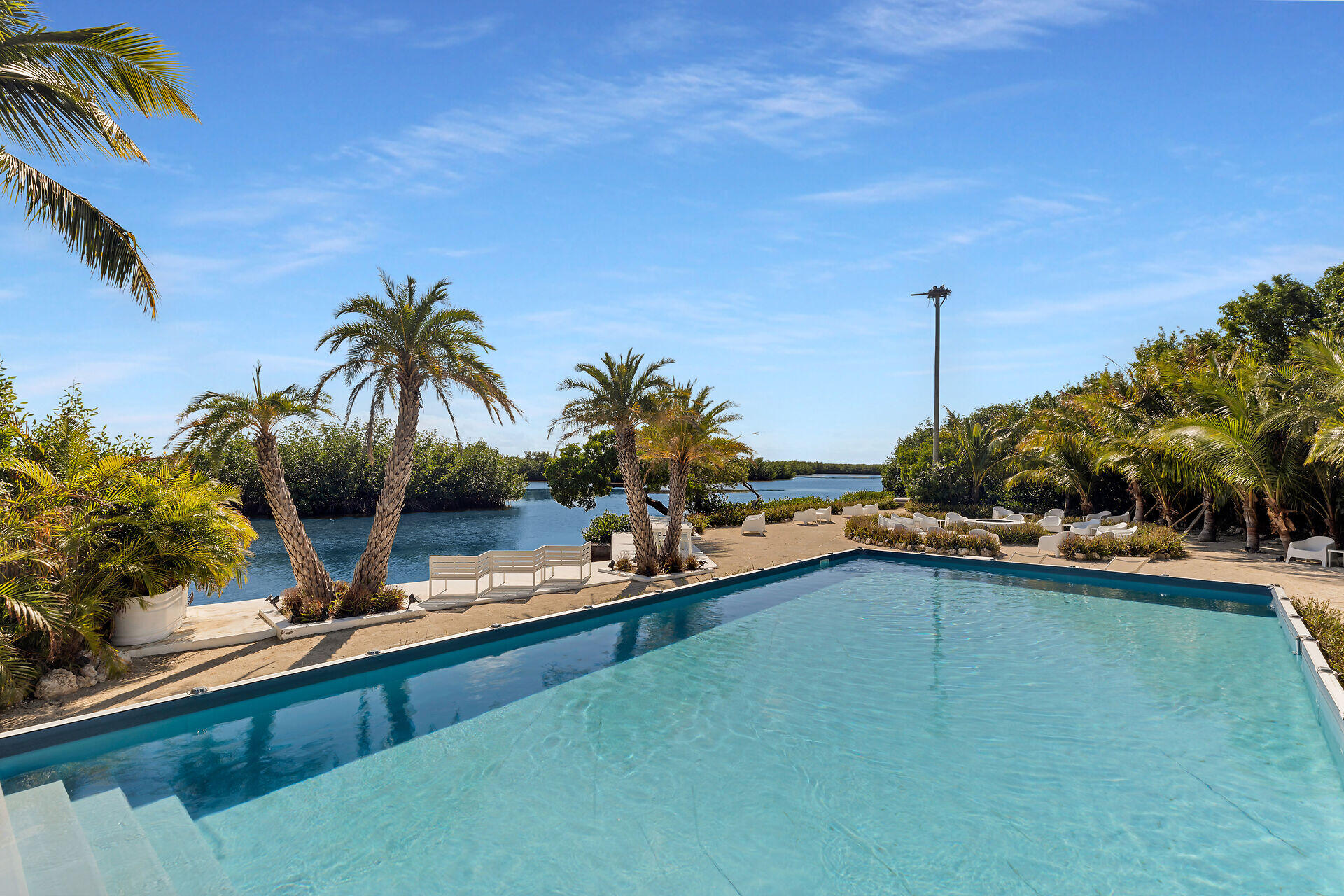 98701 Overseas Highway Key Largo, FL 33037 - Photo 5 of 47 a view of a swimming pool and lounge chair