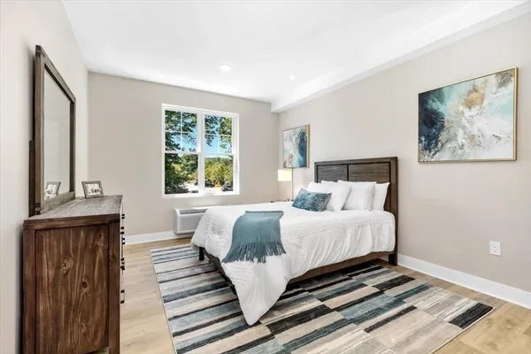 a bed sitting in a bedroom next to a window