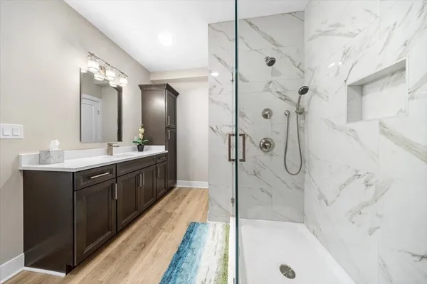 a bathroom with a double vanity sink mirror double and shower