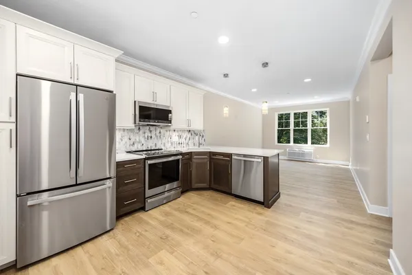 a kitchen with a refrigerator and a stove top oven