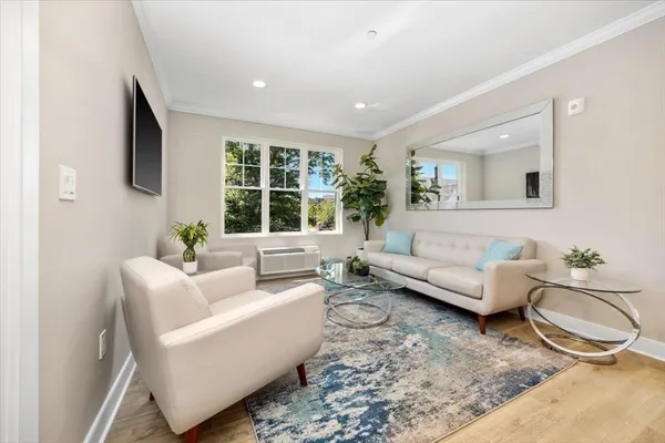 a living room with furniture and a large window