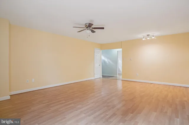 a view of a room with wooden floor and fan