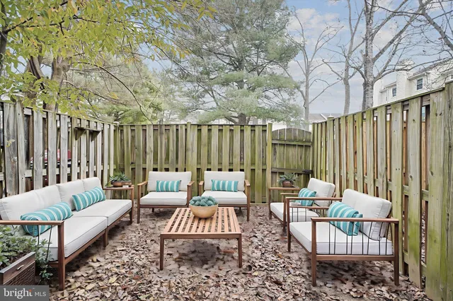 a outdoor space with patio couches and a dining table with chairs