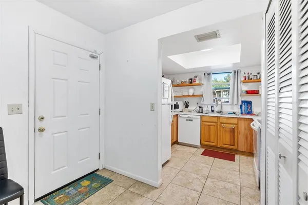 a kitchen with a refrigerator and window