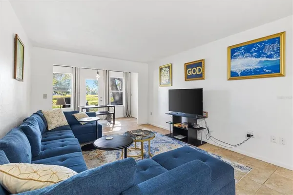 a living room with furniture and a flat screen tv