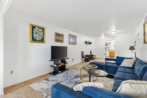 a living room with furniture and a flat screen tv