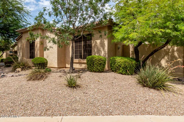 a view of a house with a tree in front