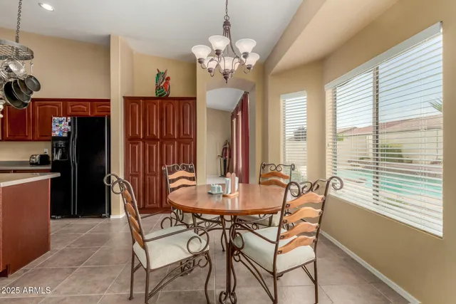 a kitchen with a sink a counter and chairs