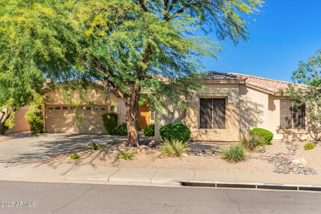 a view of a house with a tree in front