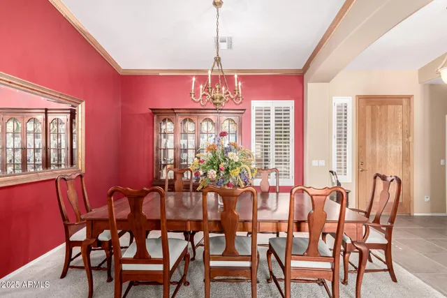a view of a dining room with furniture and a chandelier