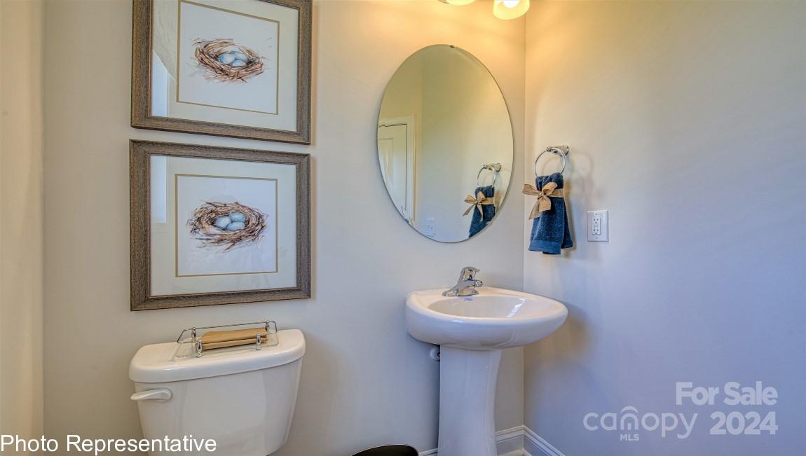 448 Wheatfield Road Fletcher, NC 28732 - Photo 24 of 47 a bathroom with a toilet a sink and a mirror