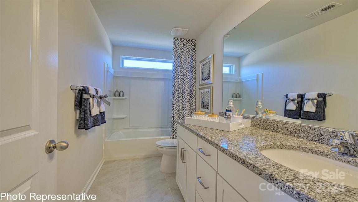448 Wheatfield Road Fletcher, NC 28732 - Photo 43 of 47 a bathroom with a granite countertop sink a toilet a mirror a vanity and shower