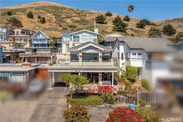 an aerial view of a houses with city view