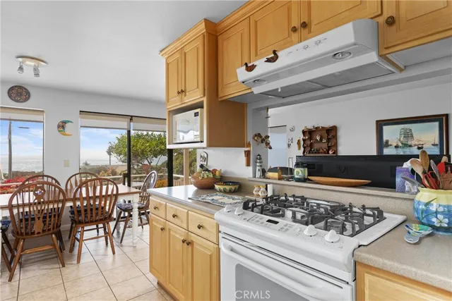 a kitchen with chairs and stove