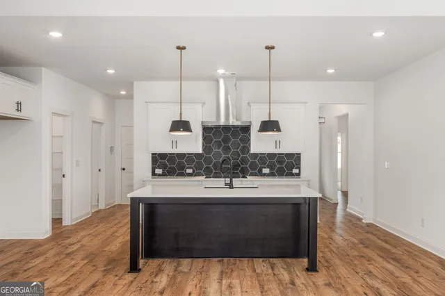 a view of an empty room with a ceiling fan and window