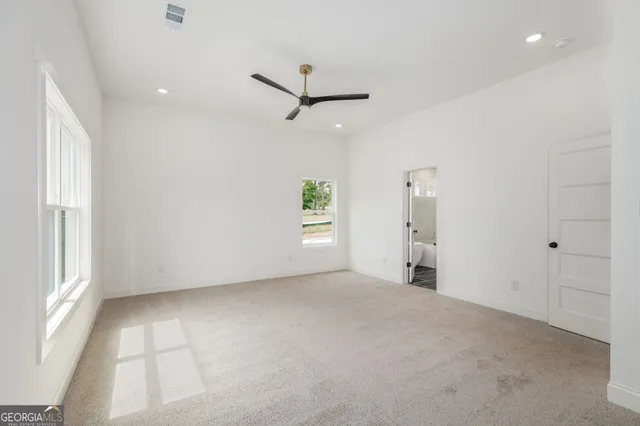 a spacious bathroom with a bathtub and shower