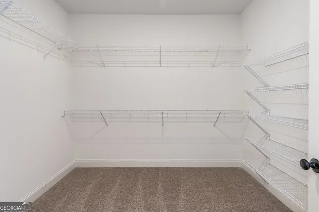 a view of a room with wooden floor and a bathroom
