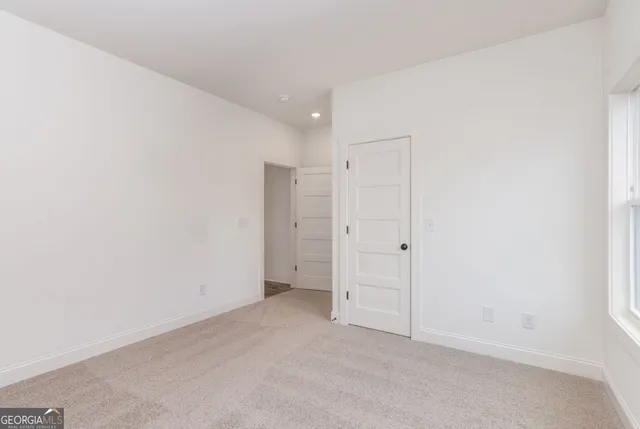 a view of house with outdoor space and tree in the background