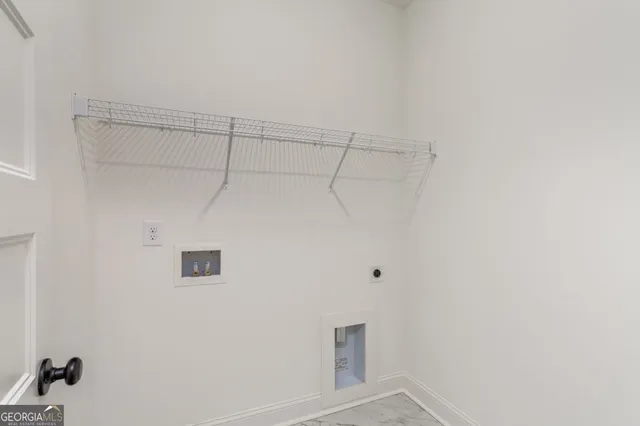 an aerial view of a residential houses with outdoor space and parking