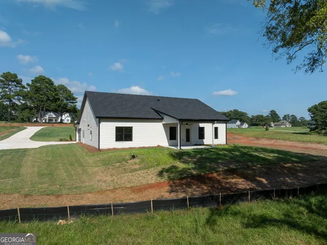 an aerial view of a house with a yard