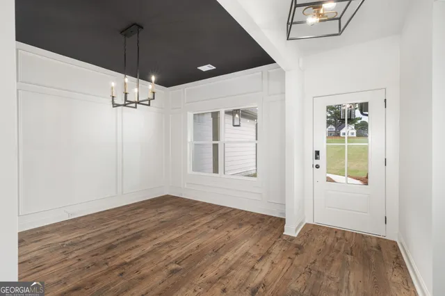 a kitchen with granite countertop a sink a counter space stainless steel appliances and cabinets