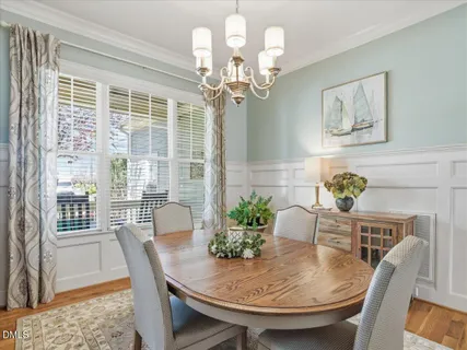 a living room with furniture a fireplace and a large window